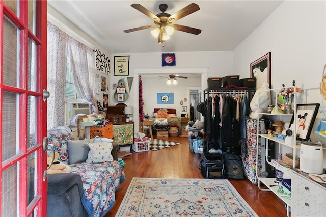 sitting room featuring ceiling fan, cooling unit, and dark hardwood / wood-style floors