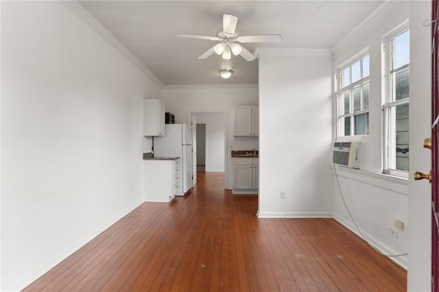 spare room featuring cooling unit, ornamental molding, dark hardwood / wood-style floors, and ceiling fan