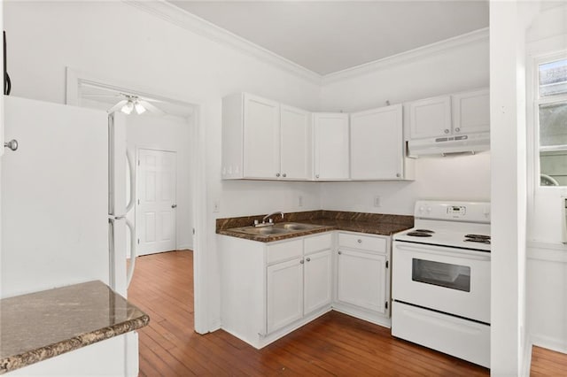 kitchen with white appliances, sink, and white cabinets