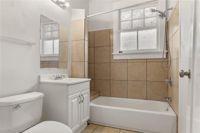 full bathroom featuring tile patterned floors, tiled shower / bath combo, vanity, and toilet