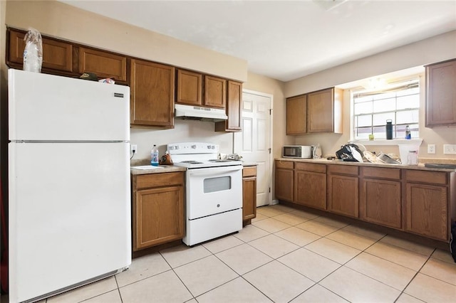 kitchen featuring white appliances and light tile patterned floors