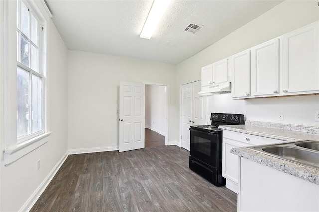 kitchen featuring black electric range, dark hardwood / wood-style floors, white cabinetry, and a textured ceiling