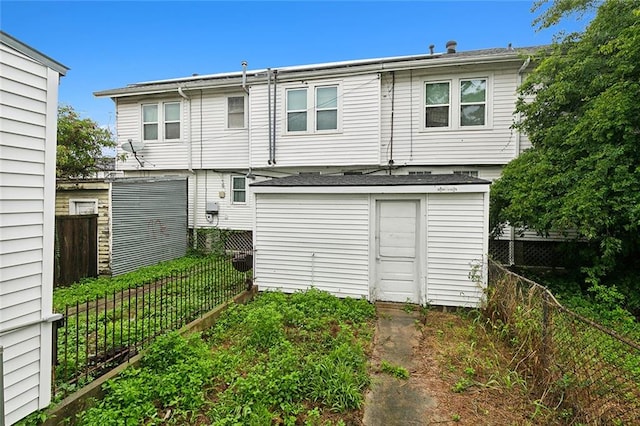 rear view of house with a storage shed