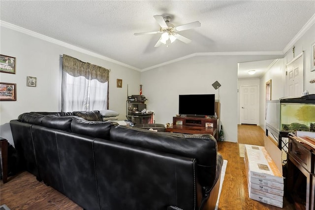 living room featuring lofted ceiling, ceiling fan, ornamental molding, and hardwood / wood-style floors