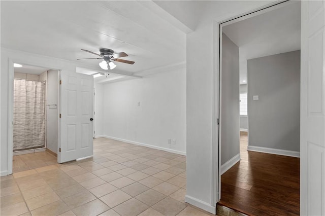 spare room featuring ceiling fan and light tile patterned floors