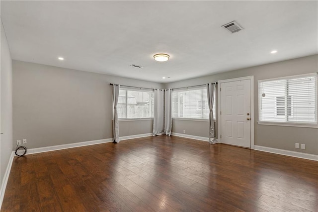 unfurnished room with dark wood-type flooring