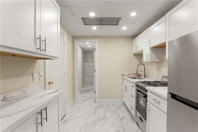 kitchen with appliances with stainless steel finishes, white cabinetry, and sink