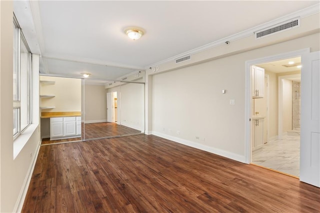 unfurnished living room featuring wood-type flooring