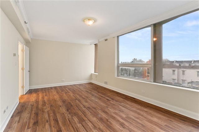 spare room with hardwood / wood-style flooring and ornamental molding