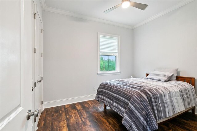 bedroom featuring crown molding, ceiling fan, and dark hardwood / wood-style flooring