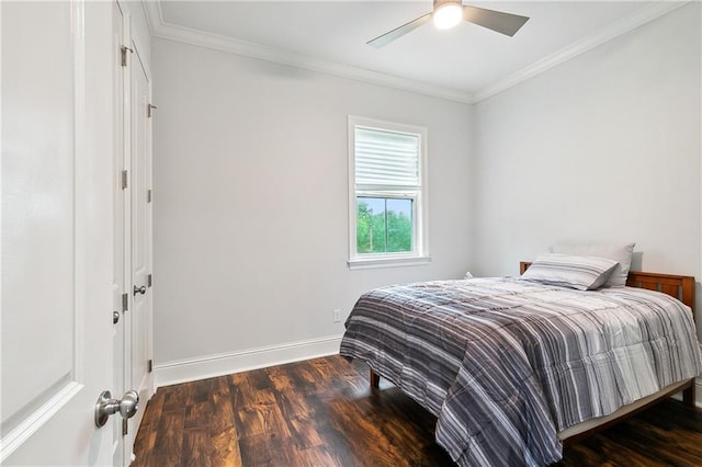 bedroom featuring ceiling fan, baseboards, wood finished floors, and crown molding