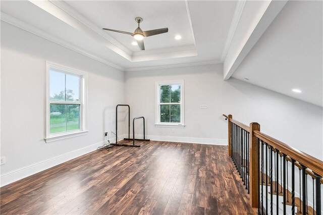 empty room with ceiling fan, dark hardwood / wood-style floors, and ornamental molding