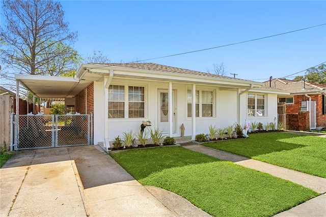 view of front of property with a carport and a front lawn