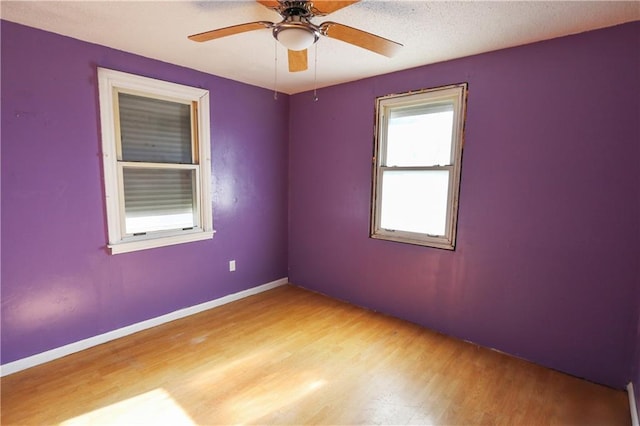 spare room featuring ceiling fan and light wood-type flooring