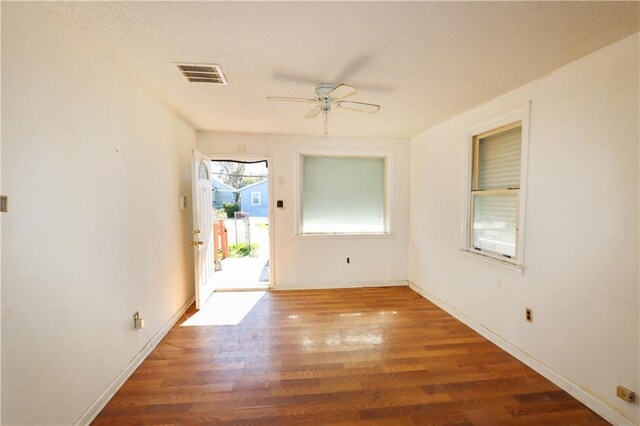 empty room featuring ceiling fan and dark hardwood / wood-style floors