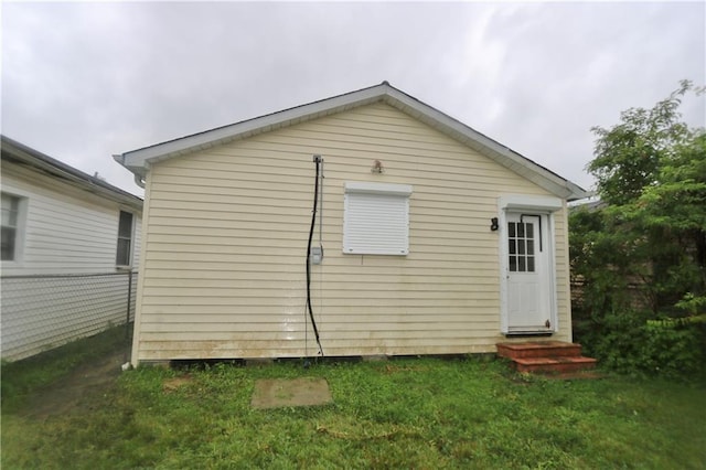 rear view of property with a yard