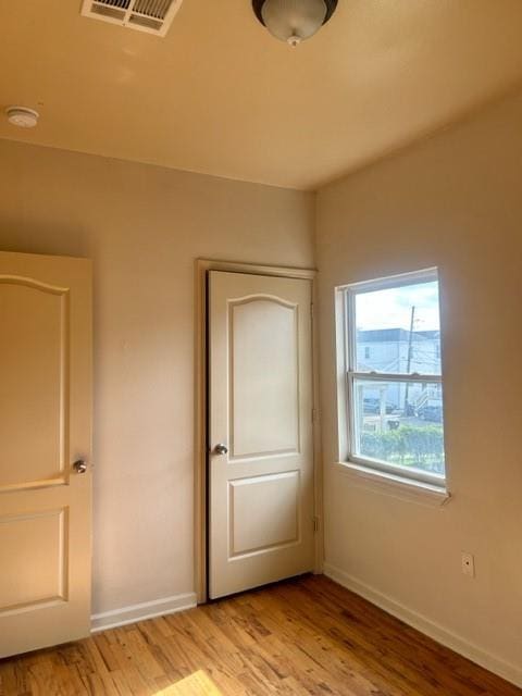 unfurnished bedroom featuring light wood-type flooring