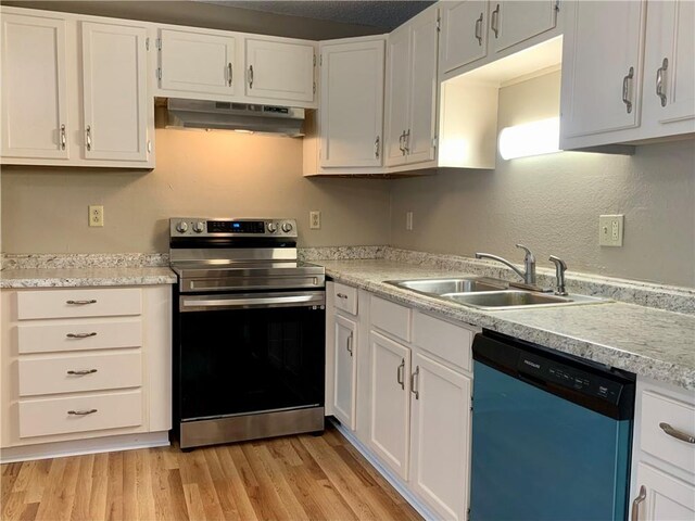 kitchen with light hardwood / wood-style flooring, sink, appliances with stainless steel finishes, and white cabinets