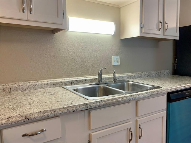 kitchen featuring white cabinetry, dishwasher, and sink