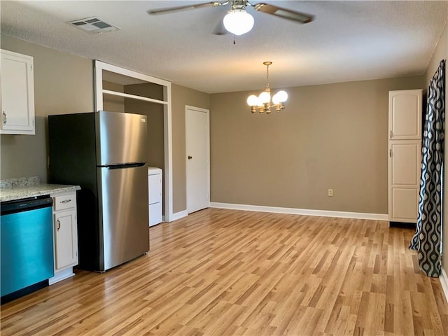 kitchen featuring decorative light fixtures, ceiling fan with notable chandelier, appliances with stainless steel finishes, light hardwood / wood-style floors, and white cabinets