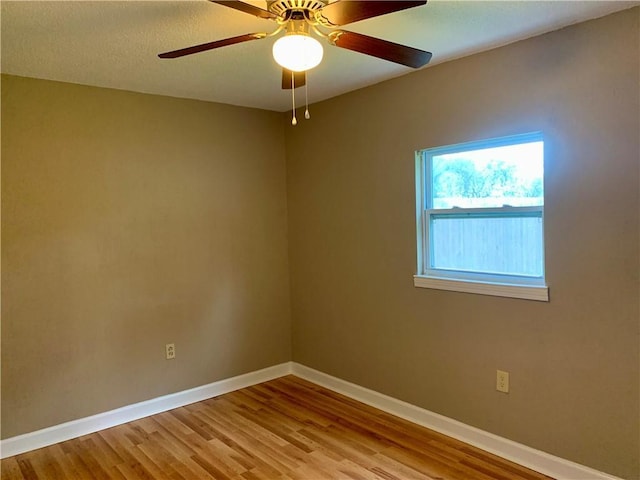 spare room featuring light hardwood / wood-style flooring and ceiling fan