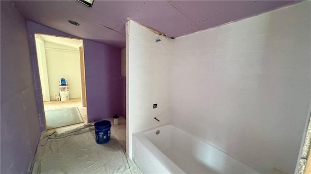 bathroom with concrete flooring and shower / bath combination