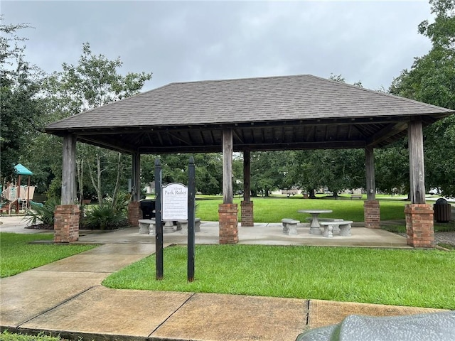 view of property's community with a playground, a gazebo, and a yard