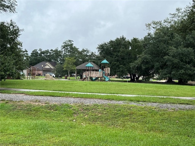 surrounding community featuring a playground and a lawn