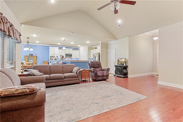 living room with high vaulted ceiling, ceiling fan, hardwood / wood-style floors, and crown molding