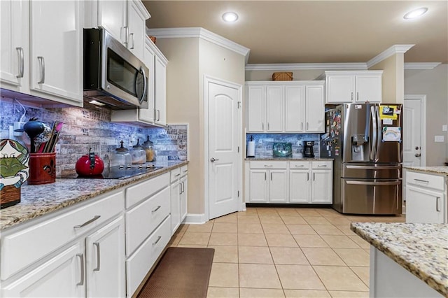 kitchen with white cabinets, appliances with stainless steel finishes, backsplash, and ornamental molding