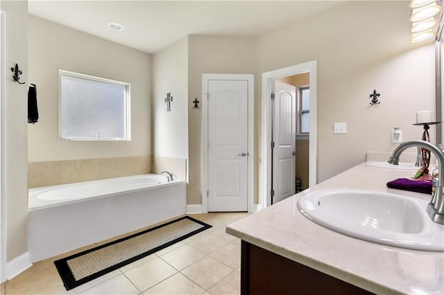 bathroom with vanity, tile patterned flooring, and a bath