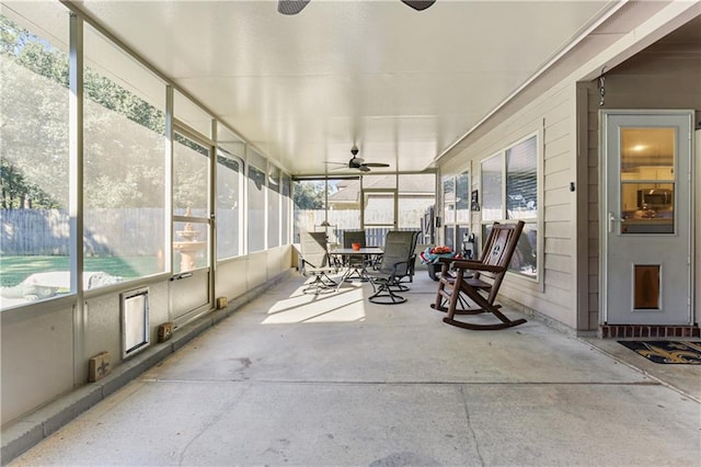 sunroom with a wealth of natural light and ceiling fan