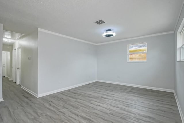 unfurnished room featuring ornamental molding and hardwood / wood-style floors