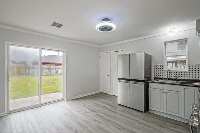 kitchen featuring light hardwood / wood-style flooring, sink, and appliances with stainless steel finishes