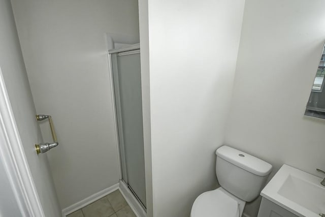 bathroom featuring tile patterned flooring, vanity, toilet, and an enclosed shower