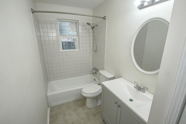 full bathroom with tile patterned flooring, toilet, tiled shower / bath combo, and vanity