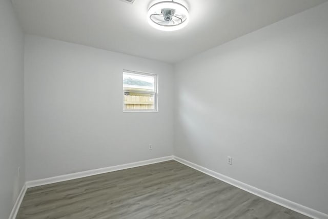 empty room with dark hardwood / wood-style floors