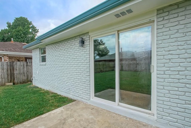 view of property exterior with a lawn and a patio