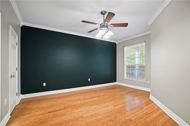 empty room with ceiling fan, light hardwood / wood-style floors, and crown molding