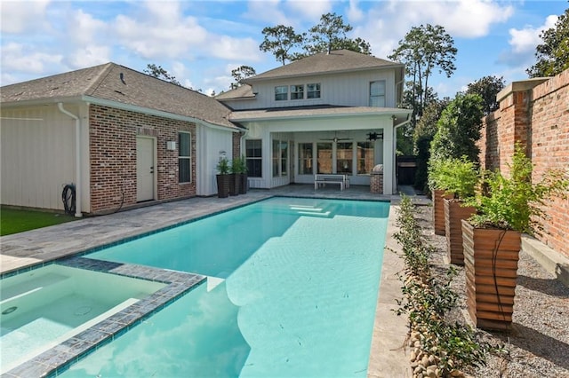 rear view of house with a fenced in pool, ceiling fan, and a patio