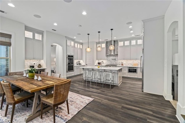 dining area featuring dark wood-type flooring