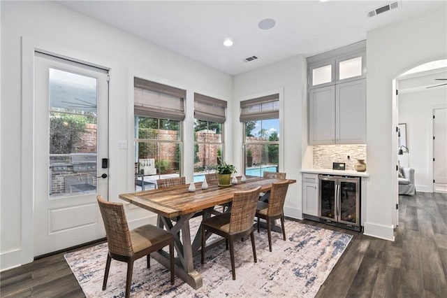 dining room featuring dark wood-type flooring and wine cooler