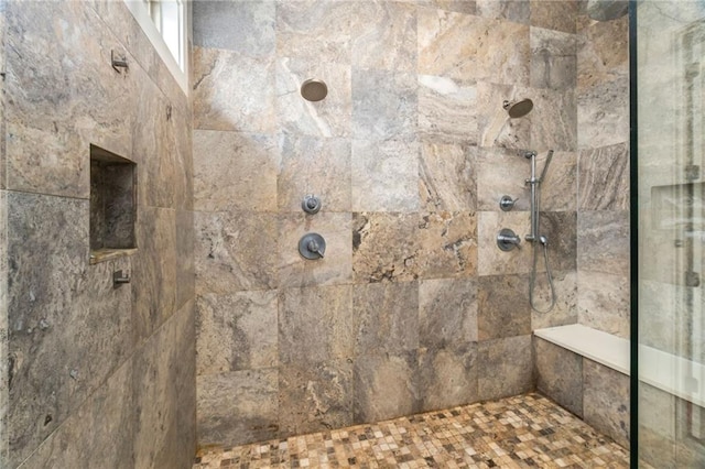 bathroom with a tile shower