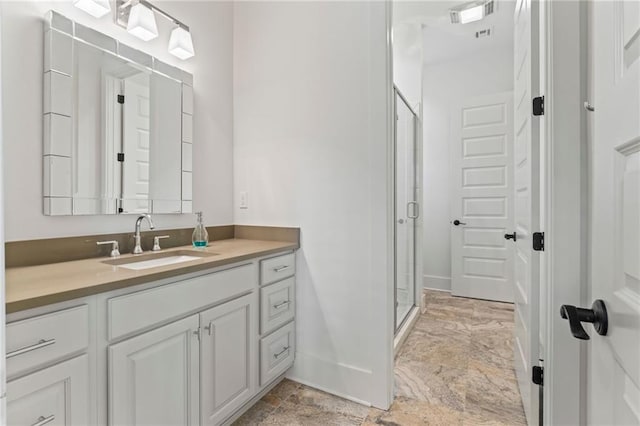 bathroom featuring walk in shower and vanity