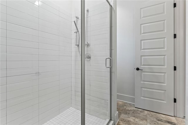 bathroom featuring a shower with shower door