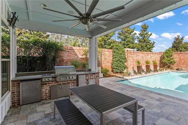 view of patio / terrace with a fenced in pool, an outdoor kitchen, area for grilling, and ceiling fan