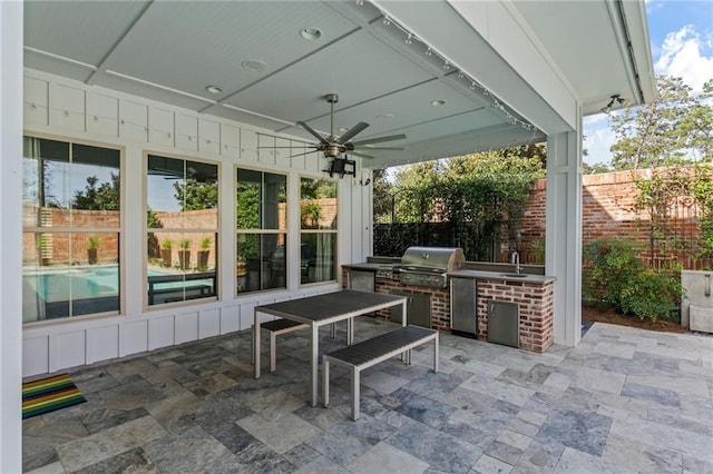 view of patio with ceiling fan, grilling area, sink, and area for grilling