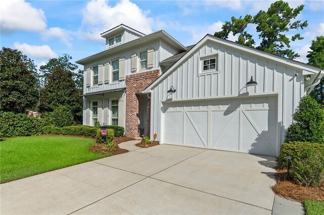 view of front of home featuring a garage and a front lawn