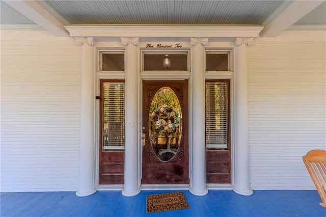 view of exterior entry featuring a porch