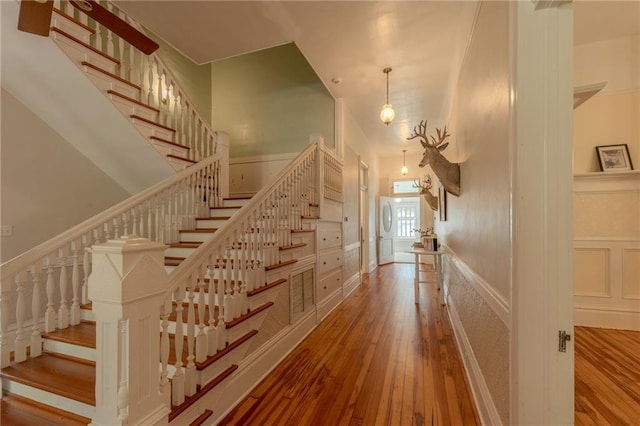 staircase with hardwood / wood-style flooring